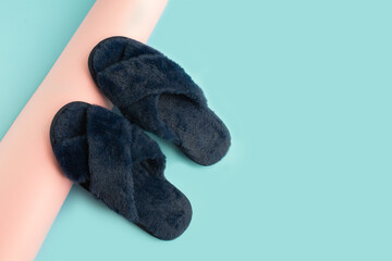 Indoor Blue home cozy slippers on a color background.