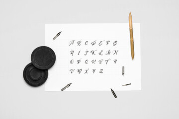 Supplies for calligraphy practice on white background
