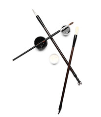 Supplies for calligraphy practice on white background