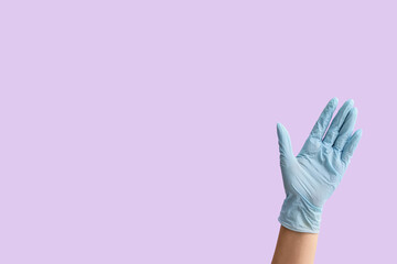 Gesturing hand in protective glove on color background