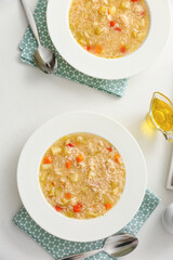 Bowls of tasty rice soup on white background