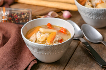 Bowl of tasty rice soup on table
