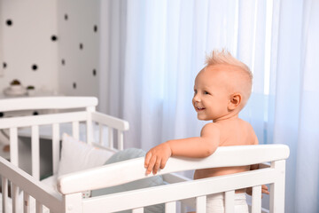 Cute little baby in bed at home