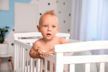 Cute little baby in bed at home