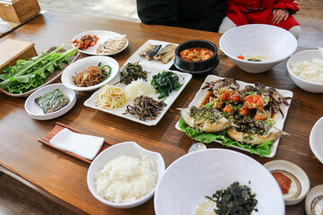 Setting a traditional Korean food table, main dish is crab preserved in soy sauce. (be called Gejang)