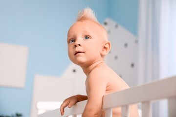 Cute little baby in bed at home