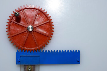red and blue  plastic gears on a white  background