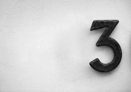 iron Number three 3 on white wall. Abstract background and texture for design. - Powered by Adobe