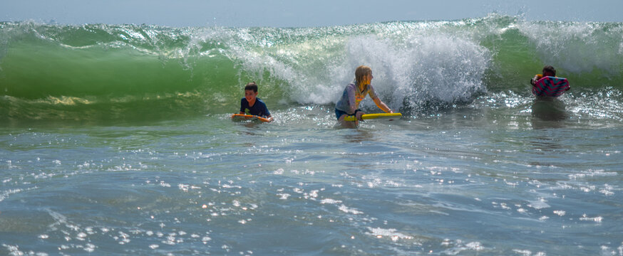 Children Having Fun Surfing On Waves At Myrtle Beach