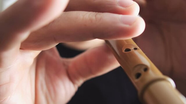 Man play traditional balkan woodwind musical instruments