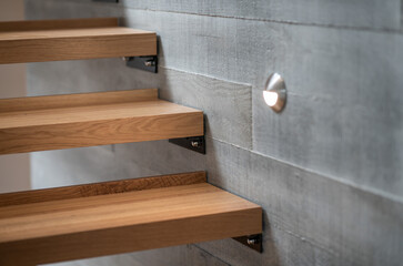 Wooden stairs against  concrete block wall