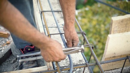 Men in a robe tool knit reinforcement for a foundation slab