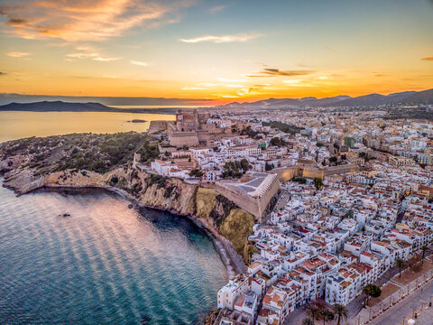 Aerial view of stunning sunset over Ibiza (Evissa) during a winter evening with view of the medieval fortress and the old town