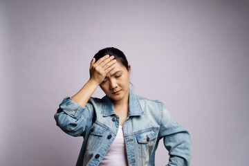 Asian woman was sick with headache touching her head isolated over white background.
