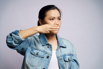 Asian woman showing three finger isolated over white background.