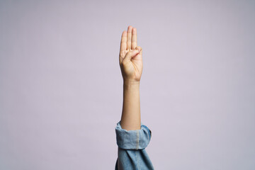Human hand showing three finger isolated over white background.