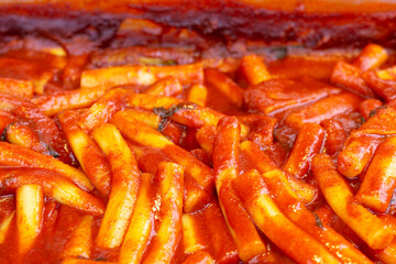 Spicy korean food topokki of a rice dumplings close-up.