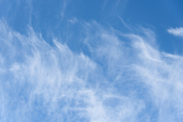 Fresh air, bright blue sky with wispy white clouds, as a nature background
