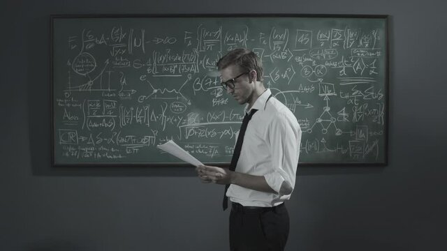 Disappointed mathematician erasing his work on the chalkboard