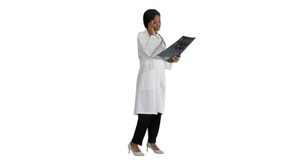 Female medical doctor reading x rays of patients brain on white