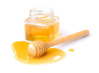 Selective focus. Honey dipper and honey in glass jar isolated on white background.