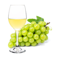 White wine in vine glass with ripe grapes isolated on white background. 