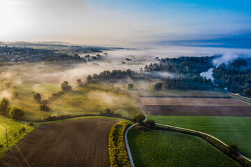 Aerial view of river landscape in the morning fog