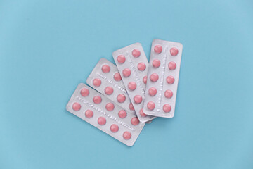 Blisters of pills on a blue background. Top view