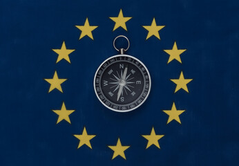 Compass on EU flag close up. Top view