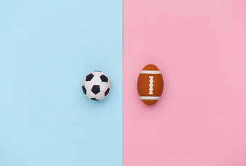 Mini soccer and rugby ball on a blue-pink pastel background. Minimalism Sport concept. Top view....