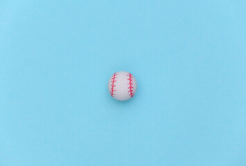 Mini baseball ball on a blue pastel background. Minimalism Sport concept. Top view. Flat lay