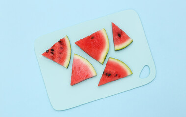Sliced slices of ripe watermelon on a blue background. Top view