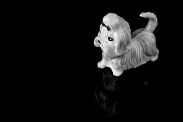 Fototapeta premium plastic toy dog on a reflective surface abstract background