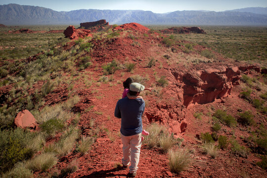person walking in the desert Los Colorados, La Rioja, Argentina