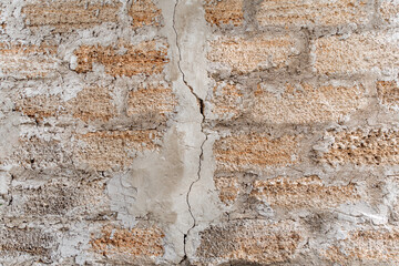 Rough texture of a brick wall made of shells. There is a crack in the middle of the wall