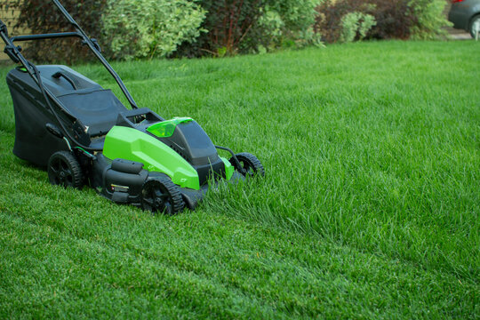 Lawn Mower On A Green Lawn.