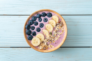 yogurt or yoghurt smoothie bowl with blue berry, banana and granola