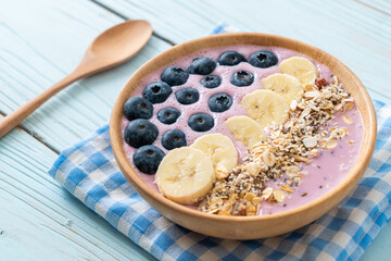 yogurt or yoghurt smoothie bowl with blue berry, banana and granola