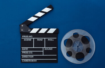 Movie clapper board and film reel on classic blue background. Cinema industry, entertainment. Top view