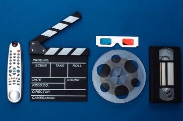 Movie clapper board and accessories on classic blue background. Retro 80s. Cinema industry, entertainment. Top view