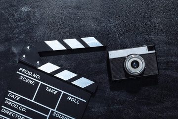 Movie clapper board and film camera on chalk blackboard. Cinema industry, entertainment