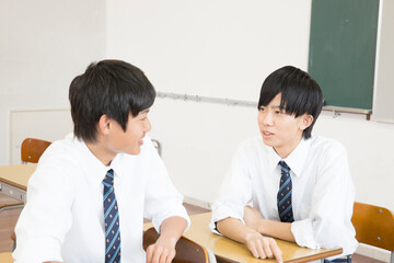 教室で会話する男子学生