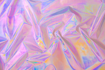 Abstract Modern pastel colored pink holographic background in 80s style. Crumpled iridescent foil...