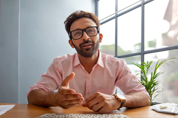Young man gesturing while talking on a video call	
