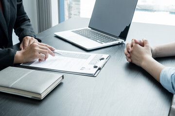 Business people hold a resume and talk to job applicants for job interviews about careers and Her...