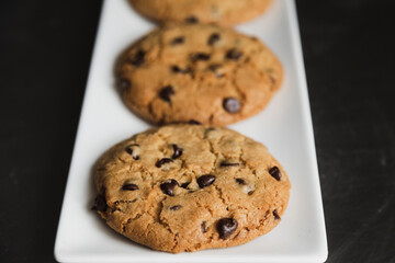 Delicious chocolate chip cookies on a white plate - homemade cookies fresh from the oven