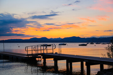 Obraz premium Sunset with landing stage in Bardolino, Italy