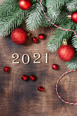 Happy new year 2021. Red Christmas decorations on the branches of the tree. Festive with wooden numbers in 2021. New Year's Flatlay. Top view from copyspace