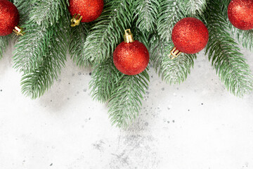 Christmas background. Red ornaments on spruce branches. Christmas Flatlay. Top view from copyspace