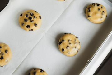 Raw chocolate chip cookies on the tray ready to bake - traditional American dessert